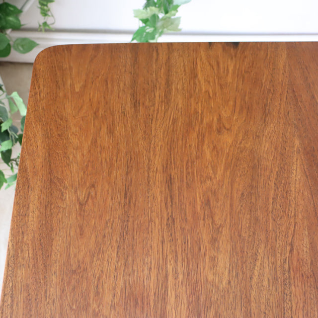 Vintage British McIntosh mid-century teak dining table with smooth wood grain and rounded corners.