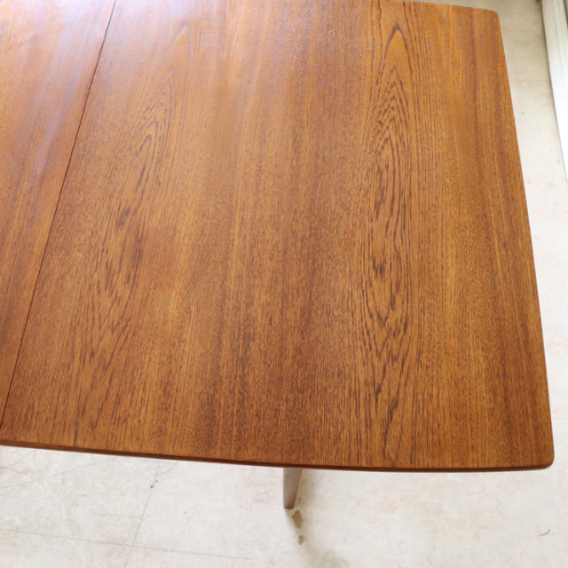 Vintage mid-century teak dining table top with warm wood grain and rounded edges, British-Denmark style.