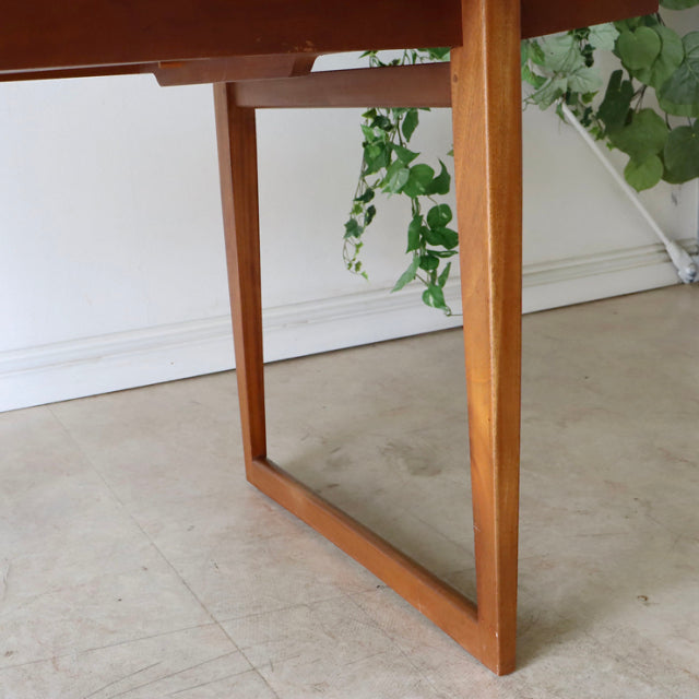 Mid-century British teak dining table leg with warm wood grain and simple rectangular frame, vintage Denmark style.