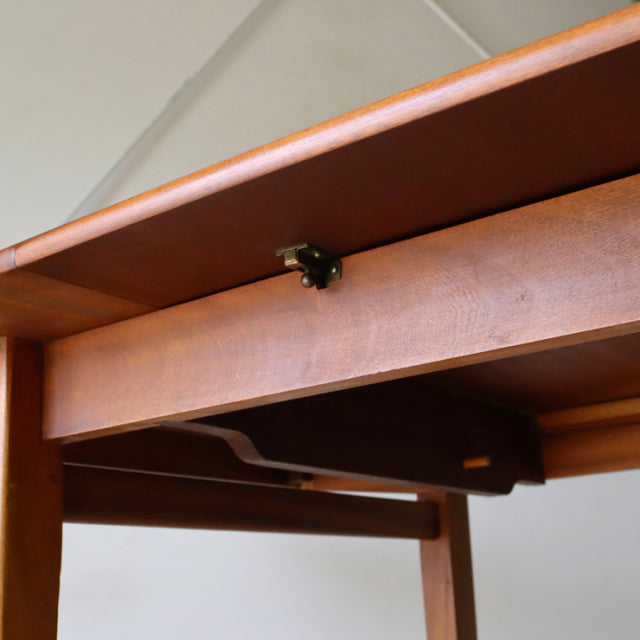 Vintage teak mid-century British dining table leg with strong wood grain and clean rectangular frame.