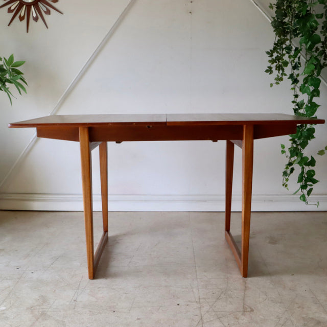 Mid-century vintage teak dining table with British-Denmark design, rectangular top and slender straight legs.