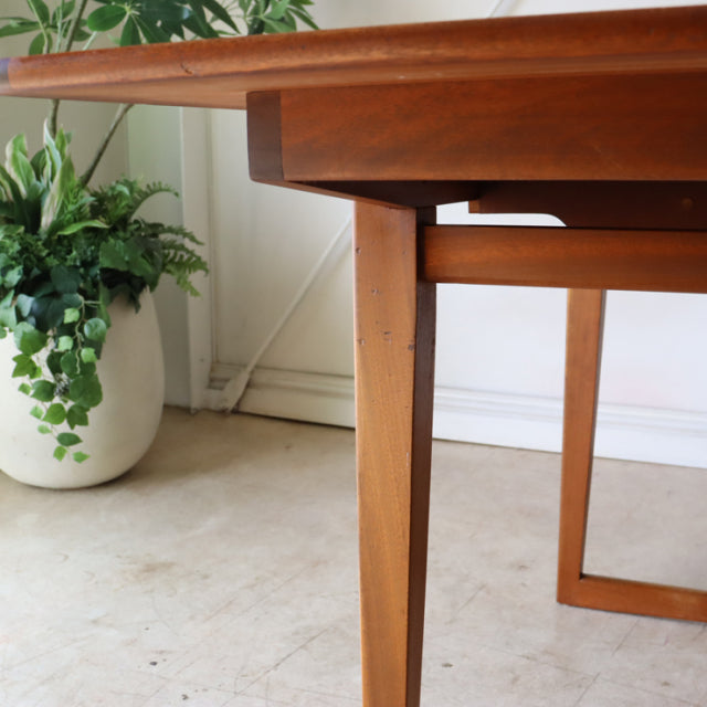Vintage teak dining table leg with tapered mid-century British design, showing smooth wood grain and sturdy rectangular.