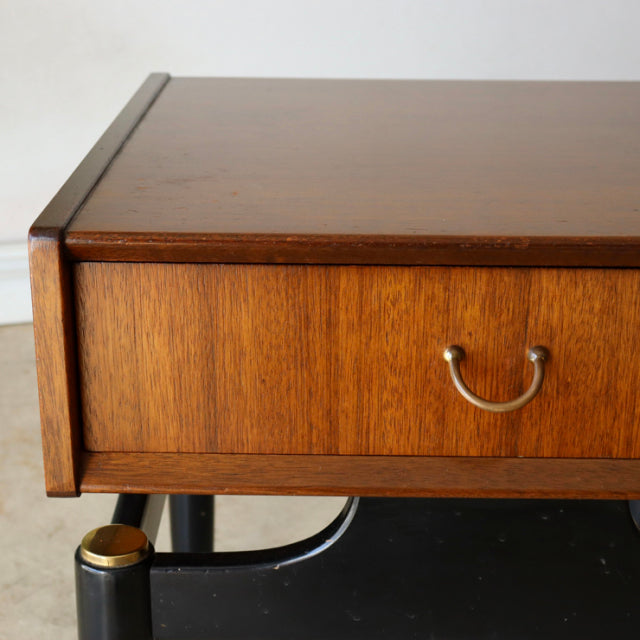 Vintage British teak bedside cabinet with mid-century design, gold-toned handle, and sleek wood grain detail.