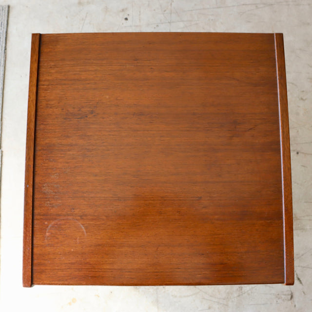 Vintage British mid-century teak bedside cabinet top with rich wood grain and clean lines.