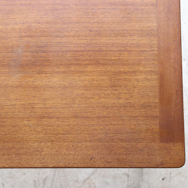 Vintage British mid-century teak coffee table top with smooth wood grain and rounded corner edge.