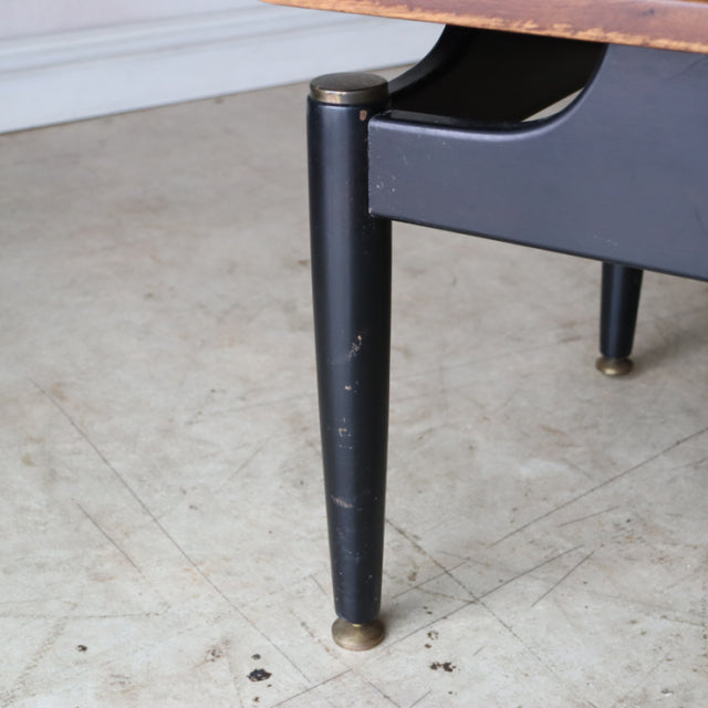 Black tapered wooden leg with brass cap on vintage British mid-century teak G-Plan coffee table.