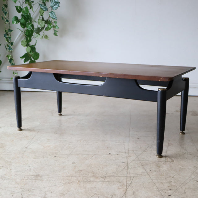 Vintage G-Plan teak mid-century coffee table with black painted frame and tapered legs, British design with clean wood grain .