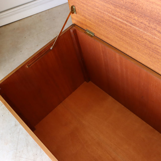 Open vintage teak storage box by Sutcliffe of Todmorden with smooth wood grain and brass hinges, mid-century British design.
