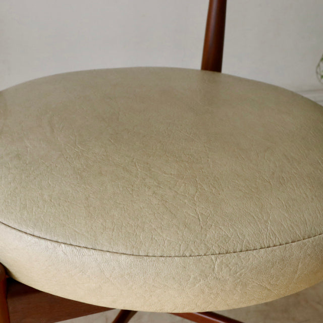 Vintage G-Plan teak dining chair seat in cream leather with smooth wood grain and slender legs.