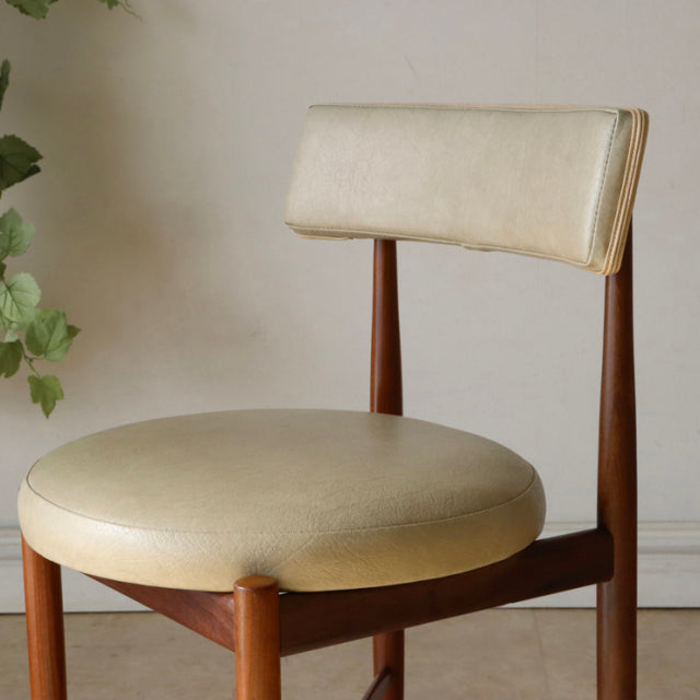 Set of four vintage G-Plan teak dining chairs with cream padded seats, mid-century British design, sleek wooden legs and.
