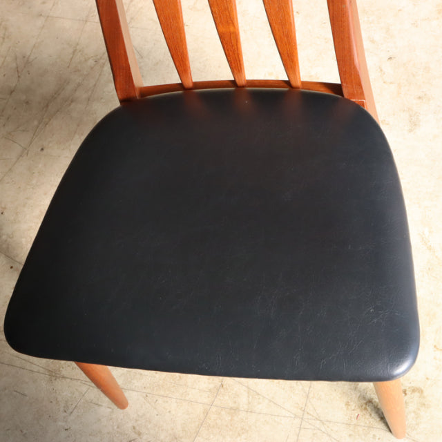 Vintage mid-century teak dining chair seat with black leather upholstery and curved wooden back slats.