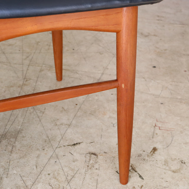 Mid-century teak dining chair leg with smooth grain, tapered design, and crossbar support from vintage British Denmark set.