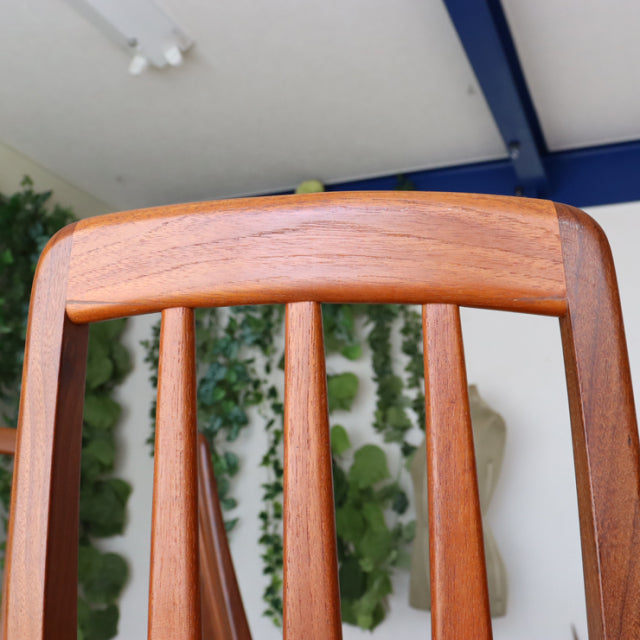 Mid-century vintage teak dining chair from Denmark with British design influence, featuring a curved backrest and tapered.