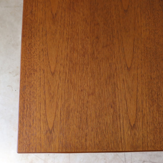 Vintage British mid-century teak dining table top with rich wood grain and warm tones.