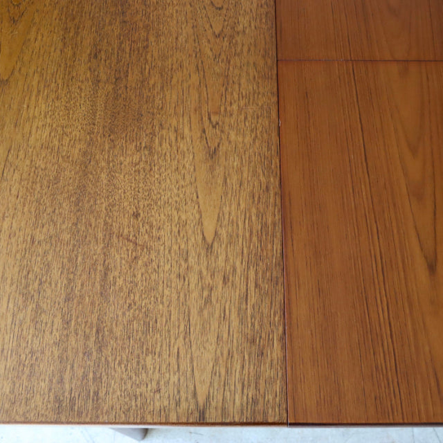 Vintage teak dining table top showing rich wood grain and smooth mid-century British craftsmanship details from.