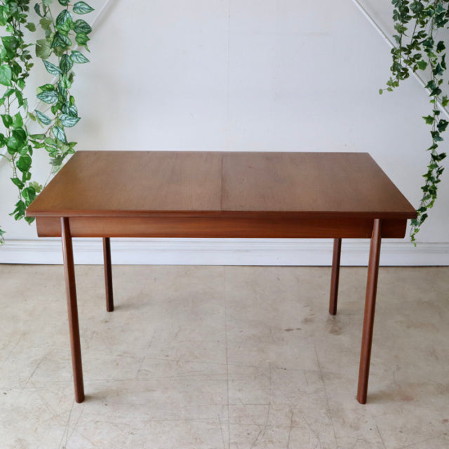 Mid-century British vintage teak dining table by Whiteandnewton with rectangular top and slender tapered legs.