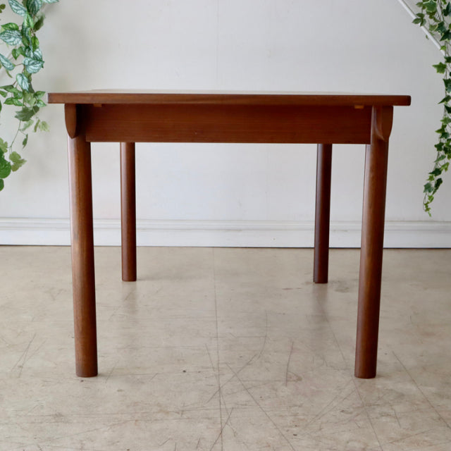 Vintage mid-century British teak dining table by Whiteandnewton with smooth wood grain and rounded legs.