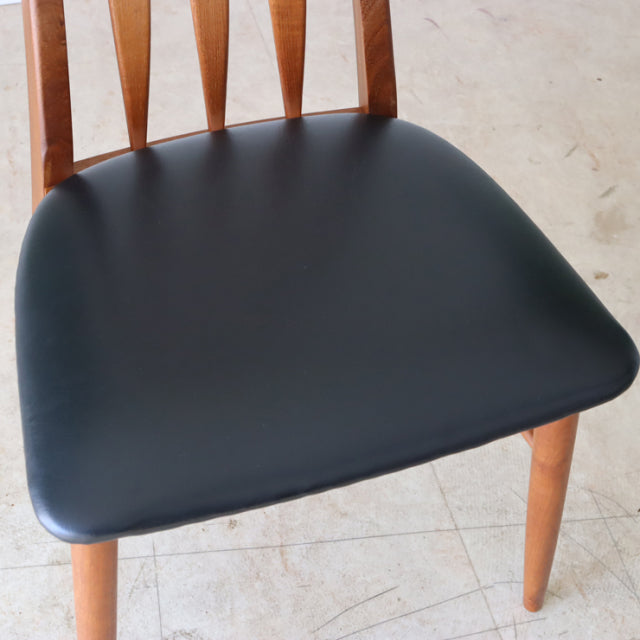 Set of two vintage mid-century Danish dining chairs by Koefoeds Hornslet, featuring teak wood frames with visible grain and.