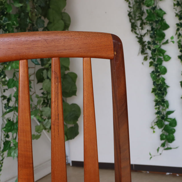 Vintage teak dining chair from Danish KOEFOEDS HORNSLET with mid-century British design, slender vertical slats, and smooth.