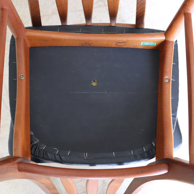 Vintage Danish teak dining chair seat frame with visible wood grain, black fabric upholstery base, mid-century British.