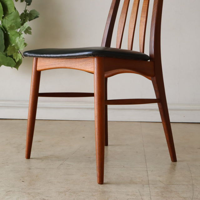 Pair of vintage Danish mid-century teak dining chairs by Koefoeds Hornslet with black leather seats and slender tapered legs.