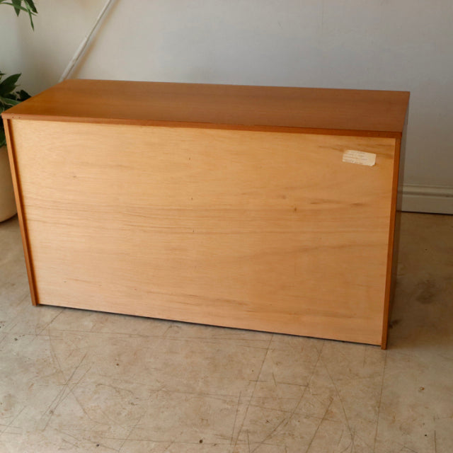 Vintage British McIntosh teak sideboard with smooth grain, clean mid-century lines, and solid rectangular form.