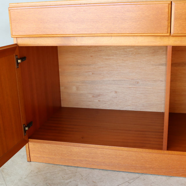 Vintage British McIntosh teak sideboard with mid-century Denmark design, showcasing rich wood grain, open door, and sleek.