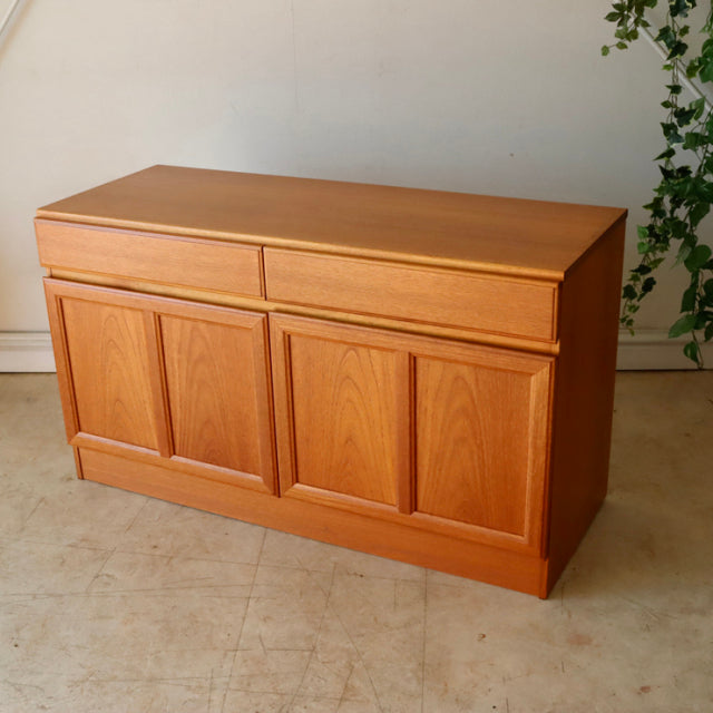 Vintage British mid-century McIntosh teak sideboard with clean lines, two drawers, and paneled doors on solid legs.