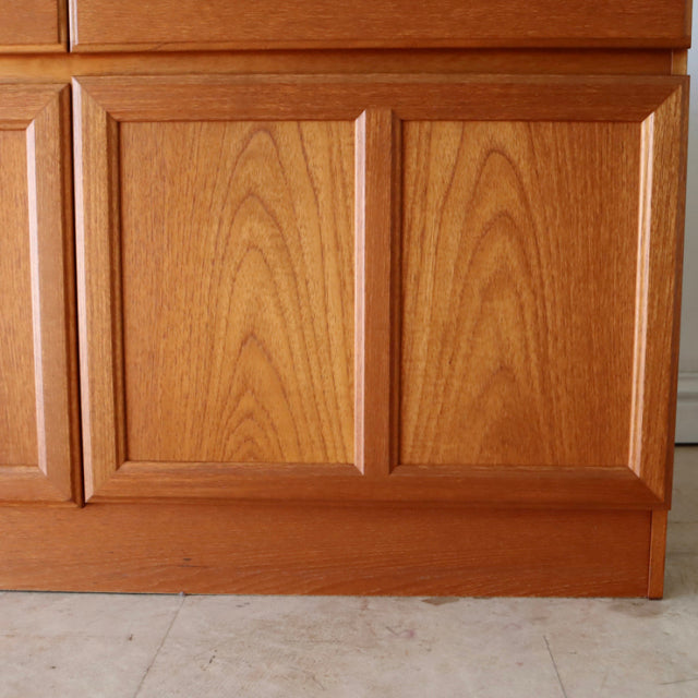 Vintage British mid-century teak sideboard by McIntosh with rich wood grain and clean-lined panel doors.
