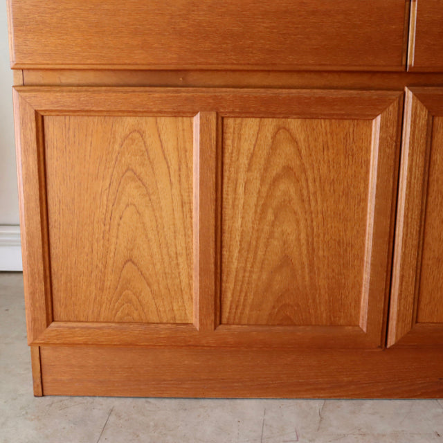 Mid-century British McIntosh teak sideboard panel with rich wood grain and clean lines.