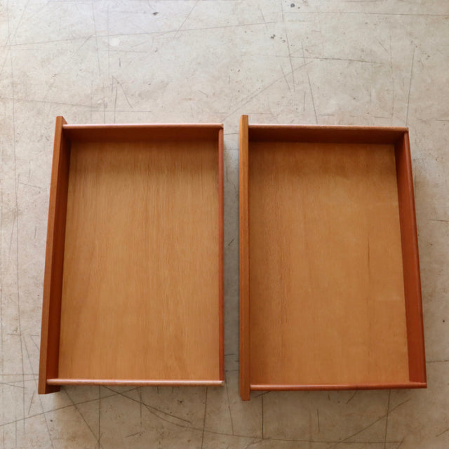 Two vintage teak drawers from British mid-century McIntosh sideboard showing smooth wood grain and solid construction.