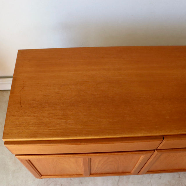 Vintage British mid-century teak sideboard by McIntosh with smooth wood grain and clean-lined form.