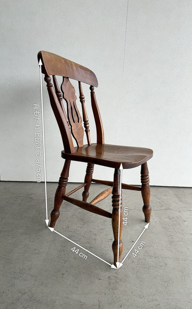 Vintage teak British mid-century dining chair with carved backrest and turned legs, classic worn patina from Denmark.