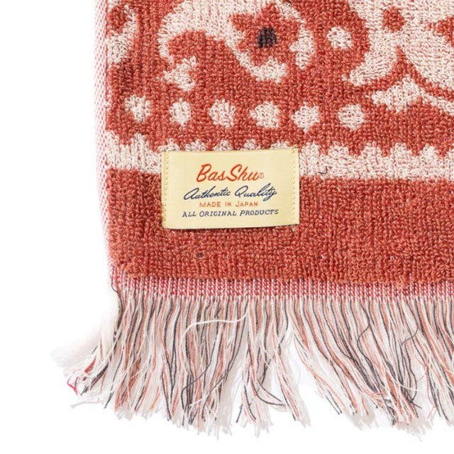 Red and white cotton pile blanket with floral bandana pattern, fringed edges, BaShu label detail.