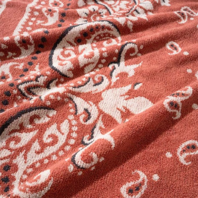Red cotton pile blanket with white vintage bandana pattern, soft textured fabric, British mid-century style.