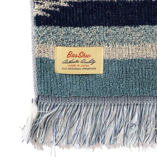 Close-up of vintage Basshu cotton pile blanket in blue shades with Native Border pattern and fringed edge, handmade in Japan.