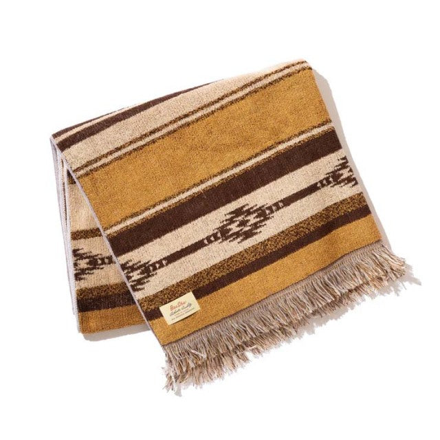 Brown cotton pile blanket with native border pattern, fringed edges, vintage British style.