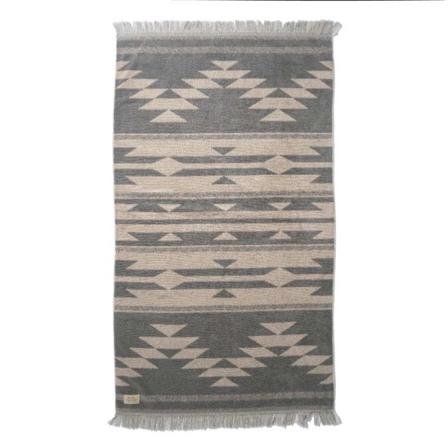 Mid-century British vintage cotton pile blanket with beige and gray native geometric motifs and fringed edges.
