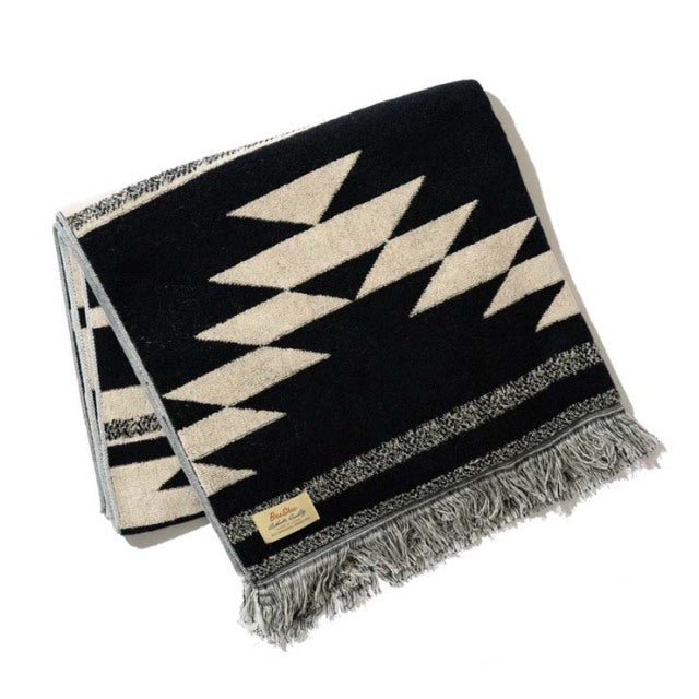 Black and cream cotton pile blanket with bold native motif and fringe edges, vintage British style.