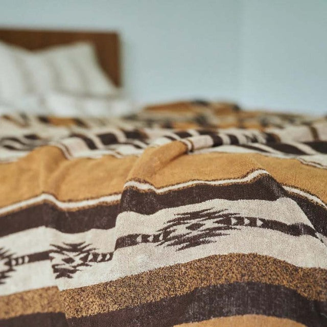 Brown cotton pile blanket with native border pattern, vintage style complement for teak mid-century furniture.