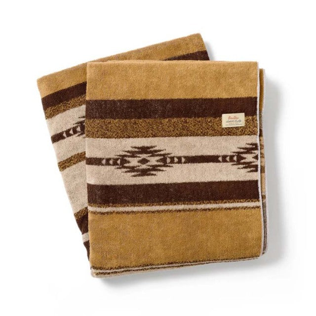 Brown cotton pile blanket with native border pattern, vintage British style, soft texture.