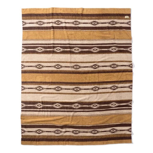 Brown cotton pile blanket with native border pattern in vintage British style.