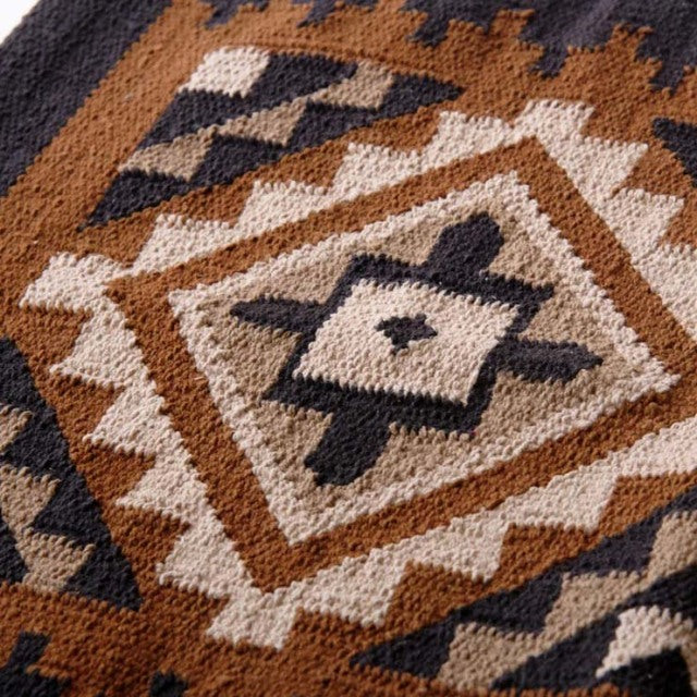 Vintage cotton rug with geometric patterns in brown, beige, and black inspired by mid-century British and Danish designs.