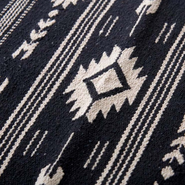 Black and white vintage cotton rug with geometric patterns inspired by British mid-century design.