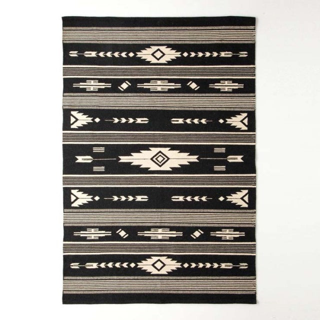 Black and beige vintage cotton rug with geometric tribal patterns, mid-century British style.