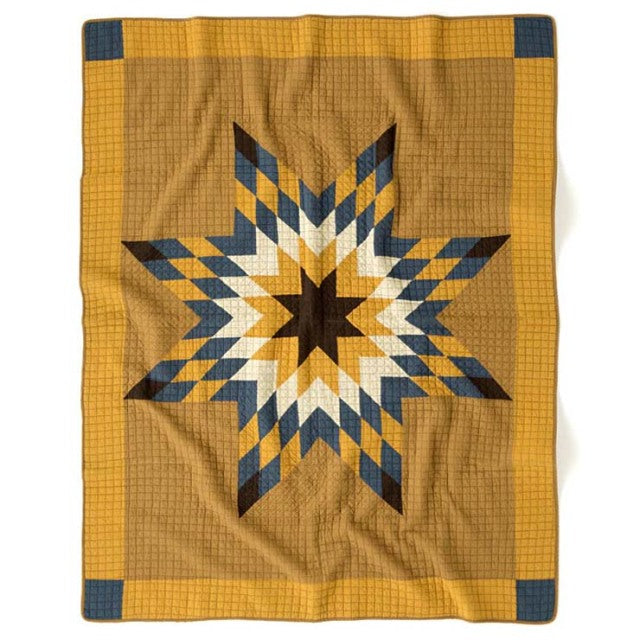 Patchwork quilt cover with vintage mustard camel background and star pattern in navy, white, and ochre, British mid-century.