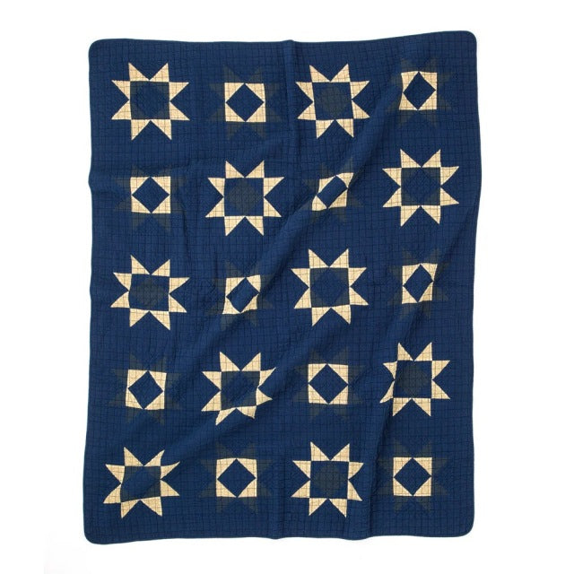 Blue patchwork quilt cover with cream star patterns, vintage British style, mid-century inspired design.