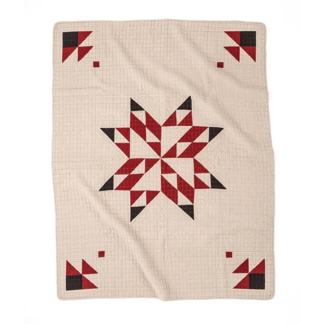 Beige patchwork quilt cover featuring a central geometric star pattern in red and black with matching corner accents,.