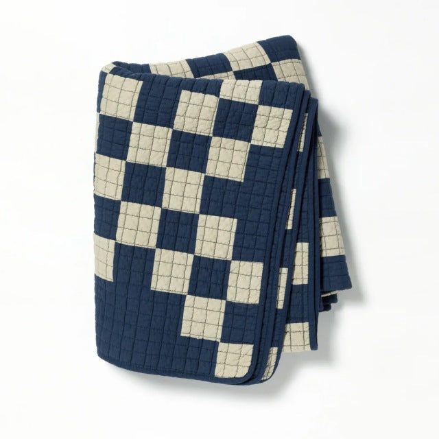 Navy and beige patchwork quilt cover with a grid pattern, textured stitching, and a soft, vintage British style fabric.