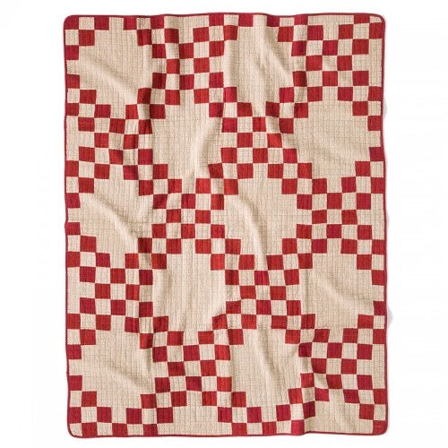 Red and cream patchwork quilt cover with vintage British mid-century design and textured stitching patterns.